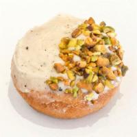 Peace'stachio Donut · Vanilla cake donut, brown butter glaze topped with crushed pistachios.