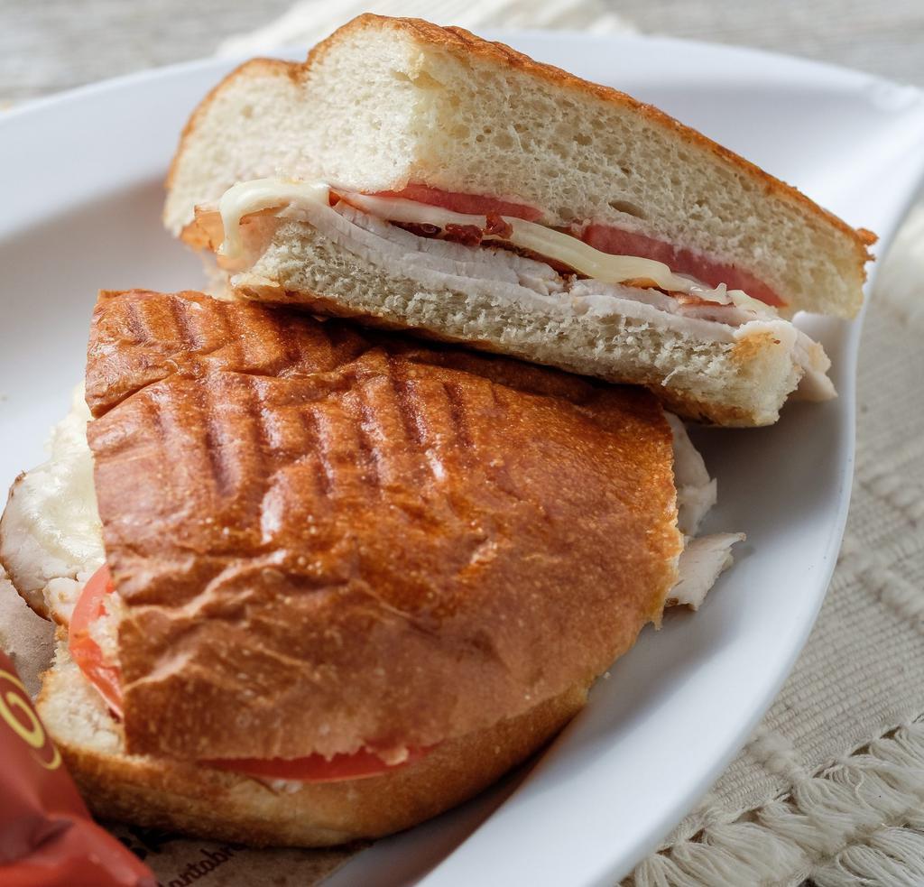 Turkey Club Panini · Turkey, bacon, tomato, provolone and honey mustard on focaccia. Served with a side of honey mustard.