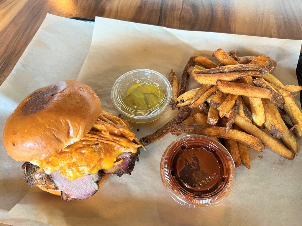 BBQ Tri Tip Sandwich · Tri tip, Grilled cheese, grilled onion, and BBQ sauce.