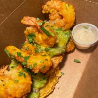 Camarones con Tostones · fried shrimp over green plantain tostones / guasacaca (avocado sauce) /aji amarillo sauce / ...