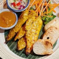 Chicken Satay · Grilled marinated chicken tenders on skewers. Served with toasted bread, peanut sauce, and c...