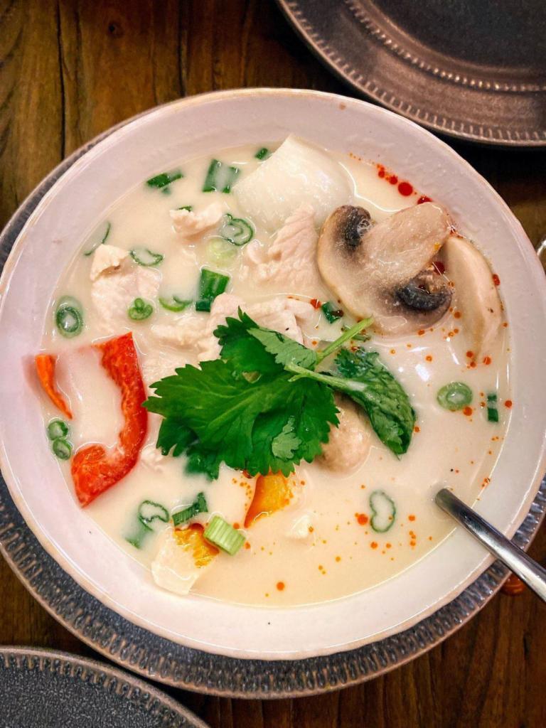 Tom Kha Soup · Chicken or vegetables. Recommended with chicken. Aromatic herbs, mildly spiced, coconut milk soup, mushroom, bell pepper, scallion, cilantro, and onion. Gluten-free.