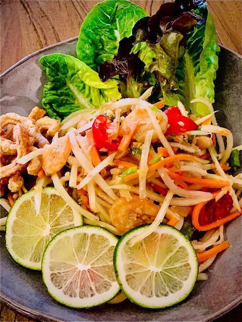 Papaya Salad (Som Tum) · Julienned green papaya with dried shrimp, tomato, peanut, chili, string beans, Thai style lime dressing, garlic and pork rind. Add-ons for an additional charge. Spicy, gluten-free.