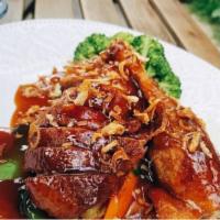Tamarind Duck · Crispy long island duck with tamarind sauce on a bed of steamed mixed vegetables served with...