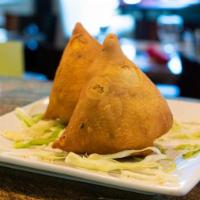 Vegetable Somosa · Our top-quality ingredients, potatoes, cilantro, green peas, and house spices wrapped in hom...