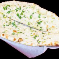 Garlic Naan · Teardrop-shaped flatbread with light garlic baked in tandoor (clay oven). Gluten.