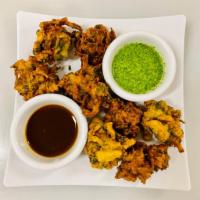 Mix Vegetable Pakora · Potato, onions, cabbage, and  spinach coated in a chickpea batter and fried