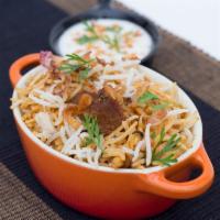 Dum Gosht Biryani · long-grain rice cooked with tender mutton and aromatic spices. Signature.