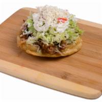 Sope · Fried sope. Topped with beans, your meat choice, lettuce, tomatoes, cheese, sour cream, and ...