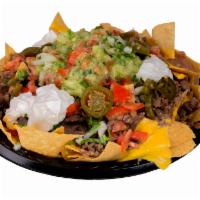 Super Nachos · Fresh fried tortilla chips topped with, beans, your meat choice, cilantro, onions, tomatoes,...