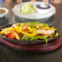 Fajitas · Sizzling hot and traditionally cooked onions, tomatoes and bell peppers, served with cilantr...