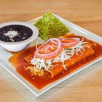 Enchiladas de Michoacan · Cotija cheese enchiladas garnished with cabbage served with cilantro rice, beans, and Mexica...