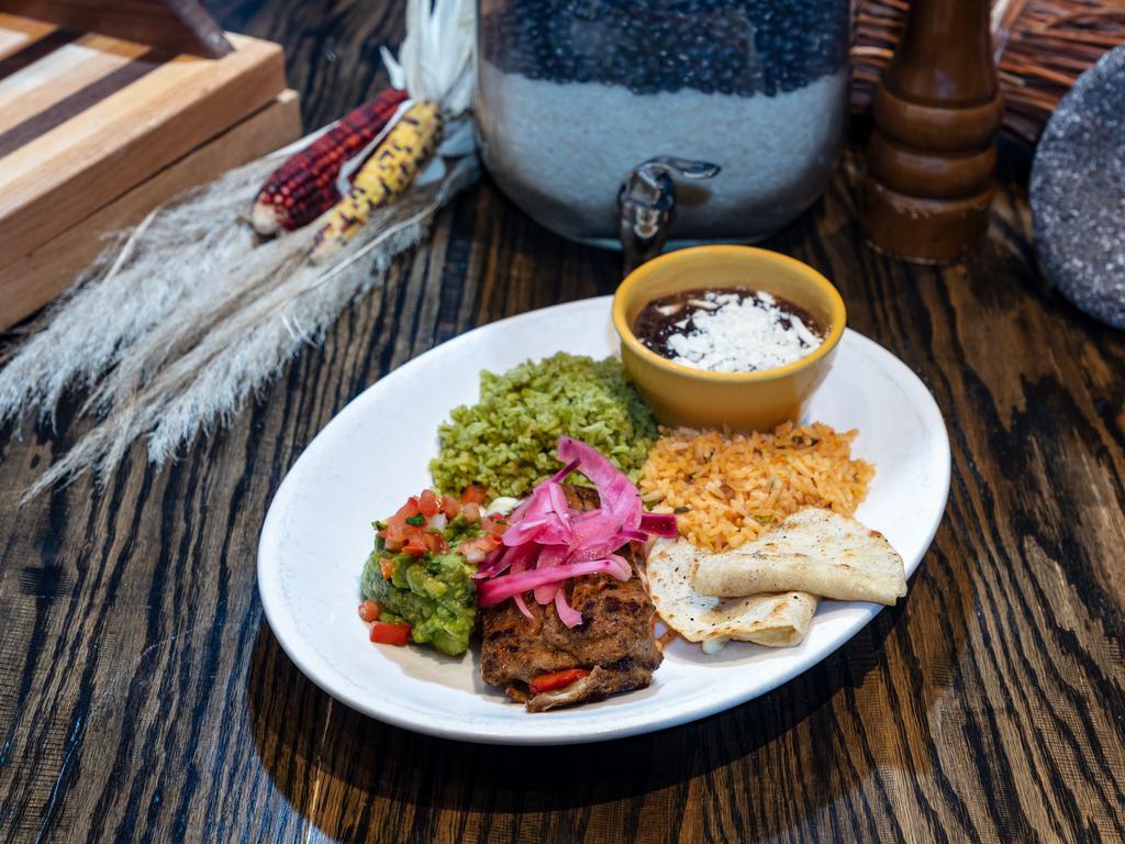 Rio's Carne Asada · Outside skirt steak grilled, stuffed with Monterey Jack and bell peppers, topped with pickled onions, served with a corn cheese quesadilla, guacamole, Rio rice, and refried beans.