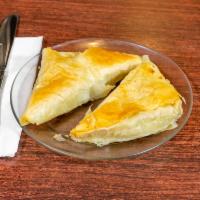 Spanakopita · 2 triangles of a delicious blend of spinach, feta and herbs wrapped in crispy filo dough.