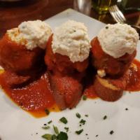 Eggplant Meatballs · Topped with our traditional pomodoro sauce and seasoned ricotta cheese, served with Italian ...
