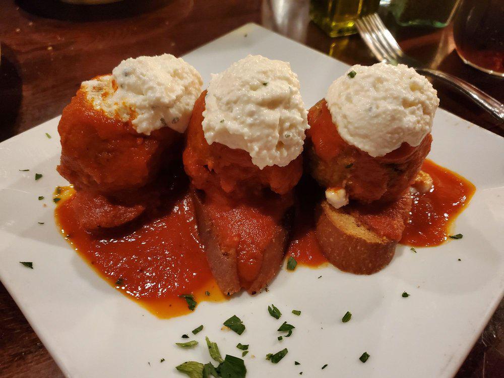 Eggplant Meatballs · Topped with our traditional pomodoro sauce and seasoned ricotta cheese, served with Italian crostini.