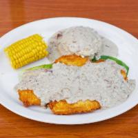 Smothered Chicken · Breaded chicken breast filet smothered in sausage gravy with mashed potatoes and corn cobbet...