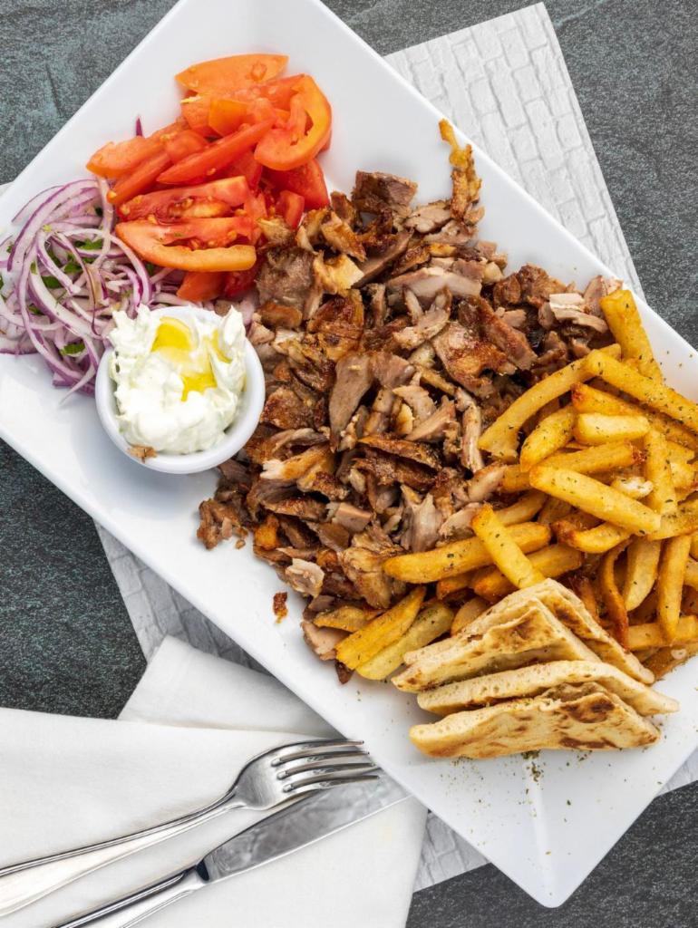 Pork Gyro Platter · Thinly sliced marinated pork gyro.All platters served with Tzatziki sauce or Niko's sauce, a side of handcut fries or rice, lettuce-tomato salad and pita bread.