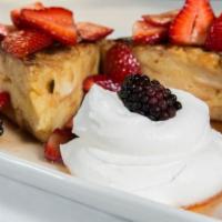 Bread Pudding French Toast · Bananas, berries, maple syrup and hand whipped vanilla cream.