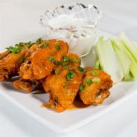 Crispy Chicken Wings · Tossed in house Buffalo sauce and served with celery and blue cheese dressing.  Gluten-free.
