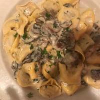 Tortellini al Funghi · Veal tortellini tossed with cream sauce and mushrooms with a touch of truffle oil.