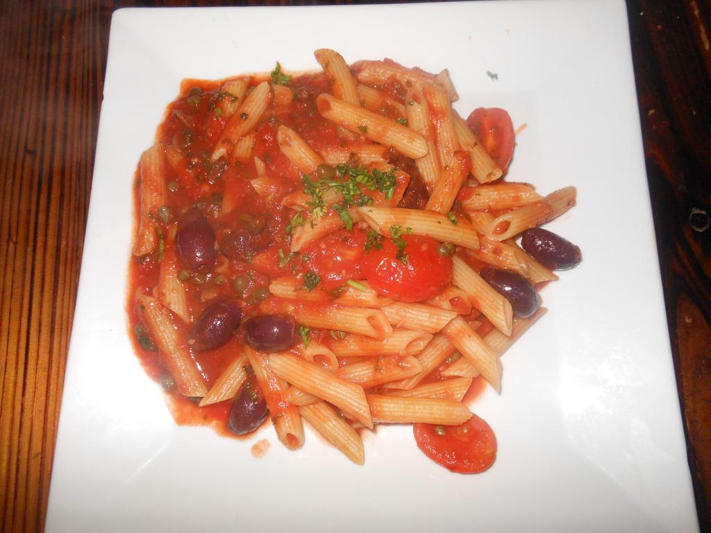 Penne alla Puttanesca · Penne pasta with capers, olives, and anchovies in fresh tomato sauce.