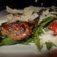 Tagliata di Manzo · Grilled strip loin steak served over arugula salad and topped with shaved Parmesan cheese.