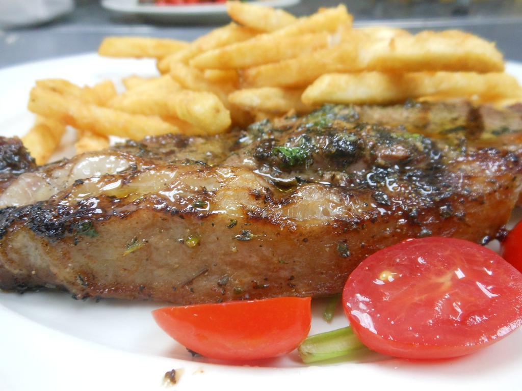 Bistecca alla Griglia  · Grilled strip loin steak marinated with herbs served with french fries 