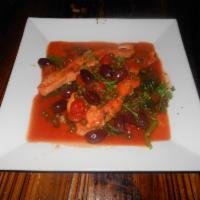 Salmone Capriccioso ·  salmon filet sauteed  with tomato sauce, black olives, and capers. Served with sauteed spin...
