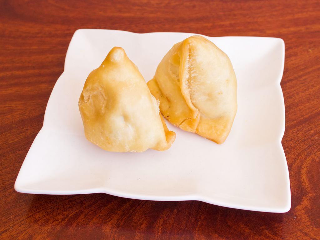 2 Piece Vegetable Samosas · Golden deep fried, flaky pastry filled with potatoes and peas.