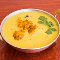 Punjabi Kadhi Pakora · An Indian yogurt green flour curry with deep fried vegetable potatoes and seasoned with spic...