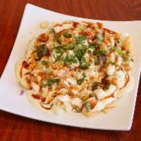 Papri Chaat · Indian style fried tortilla chips topped with boiled potatoes, chickpeas, yogurt and green c...