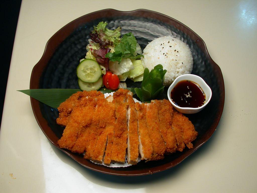 Chicken Katsu · Panko breaded chicken served with salad and rice.