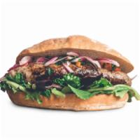 Choripan Sandwich · Crusty French bread filled with Peruvian chorizo grilled and served over a bed of seasonal m...