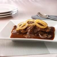 Filipino Bistek · Thinly sliced beef sirloin sauteed in onions, lemon juice, soy sauce and gravy. Topped with ...