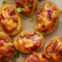 Potato Skins · Crispy baked potato skins topped with shredded cheddar cheese, bacon, sour cream and green o...