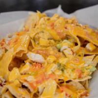 Chicken Nachos · Tortilla chips topped with lettuce, tomatoes, diced chicken breast & shredded cheddar cheese...