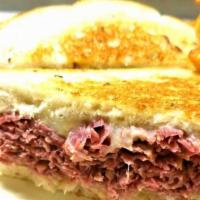 The Reuben Sandwich · Guinness braised corned beef, shaved and stacked on grilled rye bread, grilled sauerkraut, S...