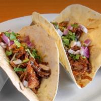 Barbeque Pork Tacos · 2 pork tacos layered and seasoned with our delicious bbq sauce. Topped with cilantro and red...