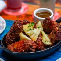 Barrio Chino Chicken Wings · A pound of award-winning Asian BBQ glazed wings. Pickled pineapple, sweet chili dipping sauc...