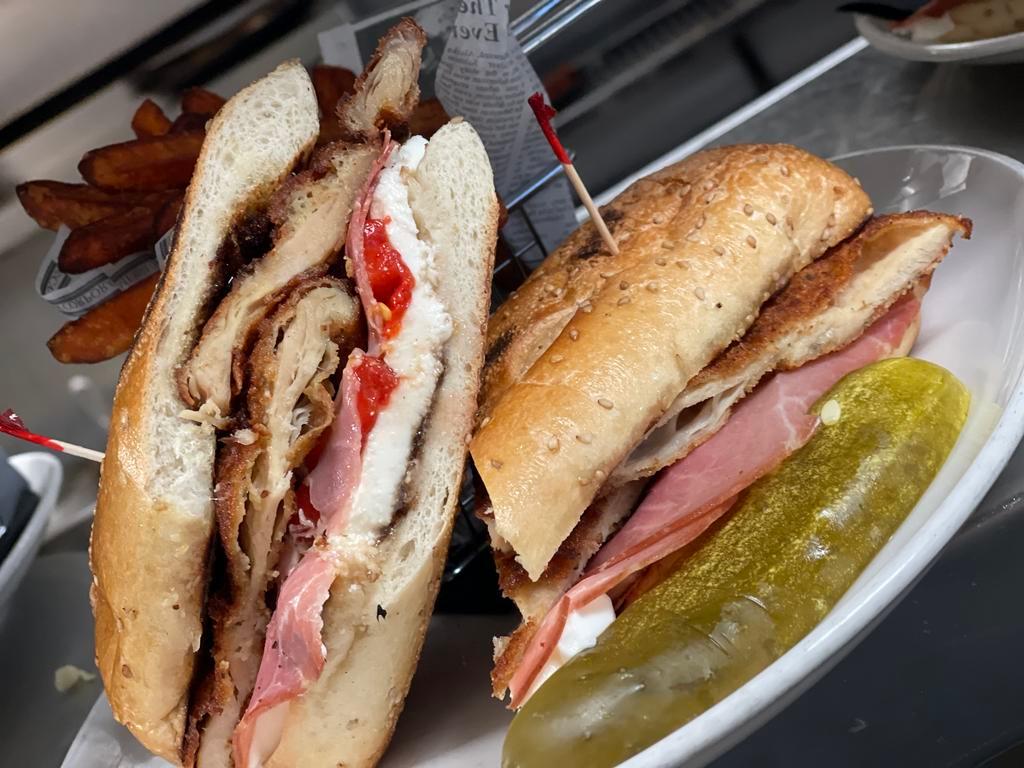 Godfather · Chicken cutlet, fresh mutz, roasted peppers, prosciutto, balsamic glaze and toasted hero. 
