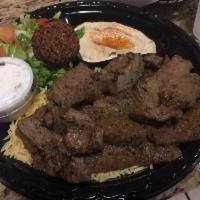 Gyro Plate · A combination of beef and lamb ground together and served with hummus, salad, rice, pita bre...