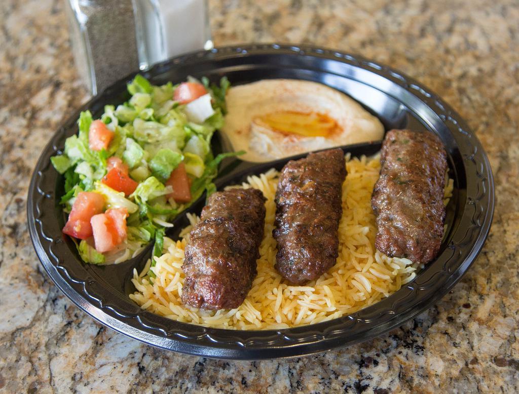 Beef Kafta Plate · Grilled ground beef with chopped tomatoes,onions and parsley, seasoned with a blend of spices.  Served with hummus, salad, rice, and pita.