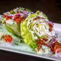 The Wedge · Iceberg Wedge, Bacon, Marinated Tomates, Blue Cheese Crumbles,
Red Onion, Parsley