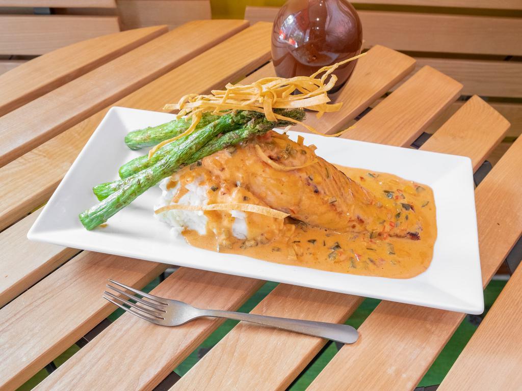 Salmon a la Parilla · Grilled filet of salmon with mashed potatoes, asparagus and lobster chipotle sauce garnish with tortilla strips.