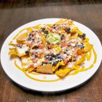 Loaded Nachos · Corn tortilla chips topped with cheese sauce (contains cashews), black beans, pico de gallo,...
