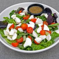 Caprese Salad · Fresh mozzarella cheese, grape tomatoes and spring mix greens.