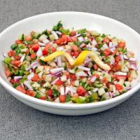 Israeli Salad · Finely chopped tomatoes, cucumbers and red onions mixed together with fresh lemon juice, oli...