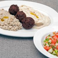 Mediterranean Combo · Hummus, baba ganoush, falafel, Israeli salad and grape leaves. Served with 2 pitas. Extra pi...