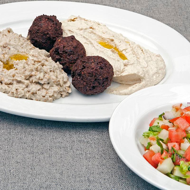 Mediterranean Combo · Hummus, baba ganoush, falafel, Israeli salad and grape leaves. Served with 2 pitas. Extra pita for an additional charge.